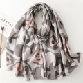 Detail of camellia flower print scarf with frayed edges and cereal magazine styling - Gray