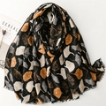 Black cotton linen scarf featuring white and yellow ginkgo leaf patterns and soft fringes - Black