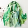 Detail of light green linen-feel scarf with plant prints and natural frayed edges - Green