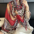 Ethnic print shawl with vintage geometric patterns and vibrant red tassel trim - Boho