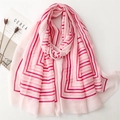 Pink striped cotton linen scarf with frayed edges displayed on a minimalist white desk - 180x88cm / Pink