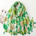 Macro view of floral print scarf with green tassel details and soft linen-feel fabric - 180cmx88cm / Green