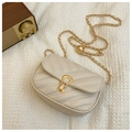 Detailed view of cream V-quilted faux leather bag with gold clasp and chain strap - White
