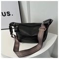 Chic black PU leather crossbody bag with geometric woven strap on a white stand - Black