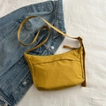 Minimalist mustard yellow crossbody bag with adjustable strap on white background - Yellow
