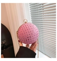 Detail of pink crystal spherical clutch bag featuring gold circular handle and chain - Pink