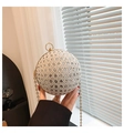Detail of a sparkling spherical evening clutch with silver rhinestones and gold chain - Silver