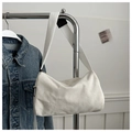 Close-up of off-white corduroy tote bag with fashion label on metal hanger - White (Without Charm)