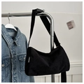 Detail of black corduroy tote bag featuring adjustable strap and fashion label on a hanger - Black (Without Charm)