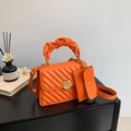 Fashionable bright orange pleated handbag with gold heart lock and matching mini pouch - Orange