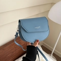 Light blue faux leather saddle bag with white lettering and adjustable strap for women - Blue