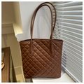 Detail of deep brown tote bag with classic diamond quilting and dual shoulder straps - Brown
