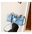 Detail view of light blue crocodile texture handbag with ruffled handle and card pouch - Blue