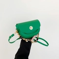 Vibrant green saddle bag with golden twist lock and decorative silk scarf chain strap - Green