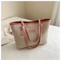 Detail of V-shaped straw weave texture and pink leather trim on large tote bag - Pink
