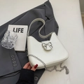 Minimalist white PU leather half-moon shoulder bag featuring a silver metal bow accent - Off White