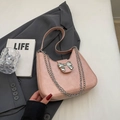 Pink matte hobo underarm bag with silver metal bow and chain detail on gray suit - Pink