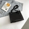 Chic black transparent PVC tote bag with thick fabric handles on a casual denim background - Black