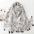 Linen feel floral scarf with leaf patterns and black tassels on white background - Black
