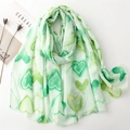 Detail of light green scarf with gold heart patterns and frayed edge on a magazine - Green(SL2403-013)