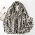 Elegant gold striped cotton-linen blend scarf with geometric patterns and fringe detail - Black
