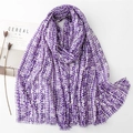 Close-up of purple geometric pixel scarf with gold threads and soft fringe edges - Purple