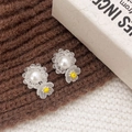 Macro shot of handmade flower stud earrings with white pearls and yellow resin petals - White