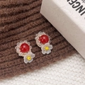 Handmade flower earrings featuring red crystal petals and white floral accents on knit fabric - Red