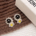 Close-up of handmade floral earrings with black stone and white crystal flower detail - Black