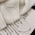 Detail view of pearl necklace with silver bow accents on soft knit sweater background - Silver Bowknot Pearl Necklace