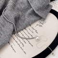 Detail of elegant pearl necklace on sweater with snake chain and large pearl pendant - Silver Pearl Necklace