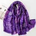 Detail of purple plaid scarf with gold stamped spiderweb patterns and soft fringe edges - Purple
