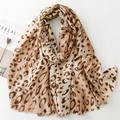 Flat lay of leopard print cotton linen scarf with frayed edges and golden sketch patterns - Khaki Leopard