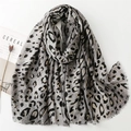 Gray leopard print scarf with gold accents and fringed edges on a minimalist white background - Grey Leopard