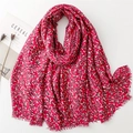 Detail of red oversized scarf featuring gold vine leaf prints and soft fringe edges - Red (SL2311-006)