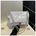 Detailed view of white glossy patent leather shoulder bag with silver chain strap - Off White