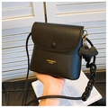 Detail of black lychee grain leather bucket bag with gold lettering and elephant charm - Black