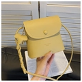 Macro view of yellow lychee grain leather bag with Fashion & Bag embossed logo - Light Yellow