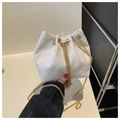 Detail of white corduroy bucket bag featuring gold chain strap and pearl drawstring accents - White