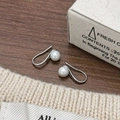 Elegant pearl earrings with S-shaped silver hooks on a rustic wooden background - Silver (A-847-Silver)