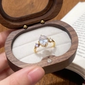 Elegant gold-plated ring with large oval zircon in a vintage wooden jewelry box - Gold