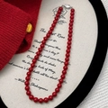Macro view of vintage red beaded necklace with silver clasp on white fabric surface - Red 8mm (B-232-8mm)
