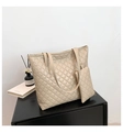 Detail of beige quilted tote bag with matching mini pouch on a black surface - Khaki