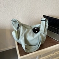 Mint green nylon crossbody bag with adjustable strap and decorative plush pendant - With Pendant / Green