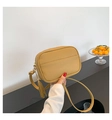 Detail of crossbody bag featuring ginger leather texture and stylish tassel ornament - Khaki