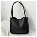 Close-up of black leather tote bag featuring central vertical stitching and long handles - No Pendant / Black