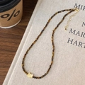 Tiger eye stone bead necklace with a golden cat pendant on a beige linen surface - Tiger Eye Round Bead Cat Head Pendant Style (B-158)