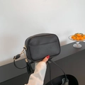 Classic black pebbled PU leather crossbody bag with gold chain and trendy tassel detail - Black