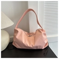 Detail of pink nylon shoulder bag showing soft pleated texture and black drawstring accent - Pink
