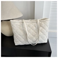 Off-white quilted tote bag with diamond stitching and elegant leather handles - White